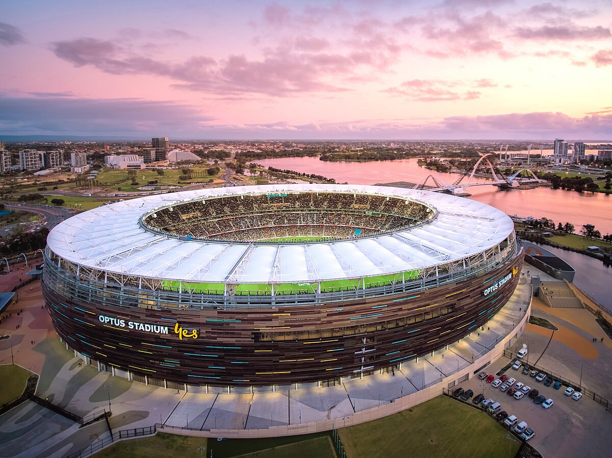 Optus Stadium beside the Swan River at dusk